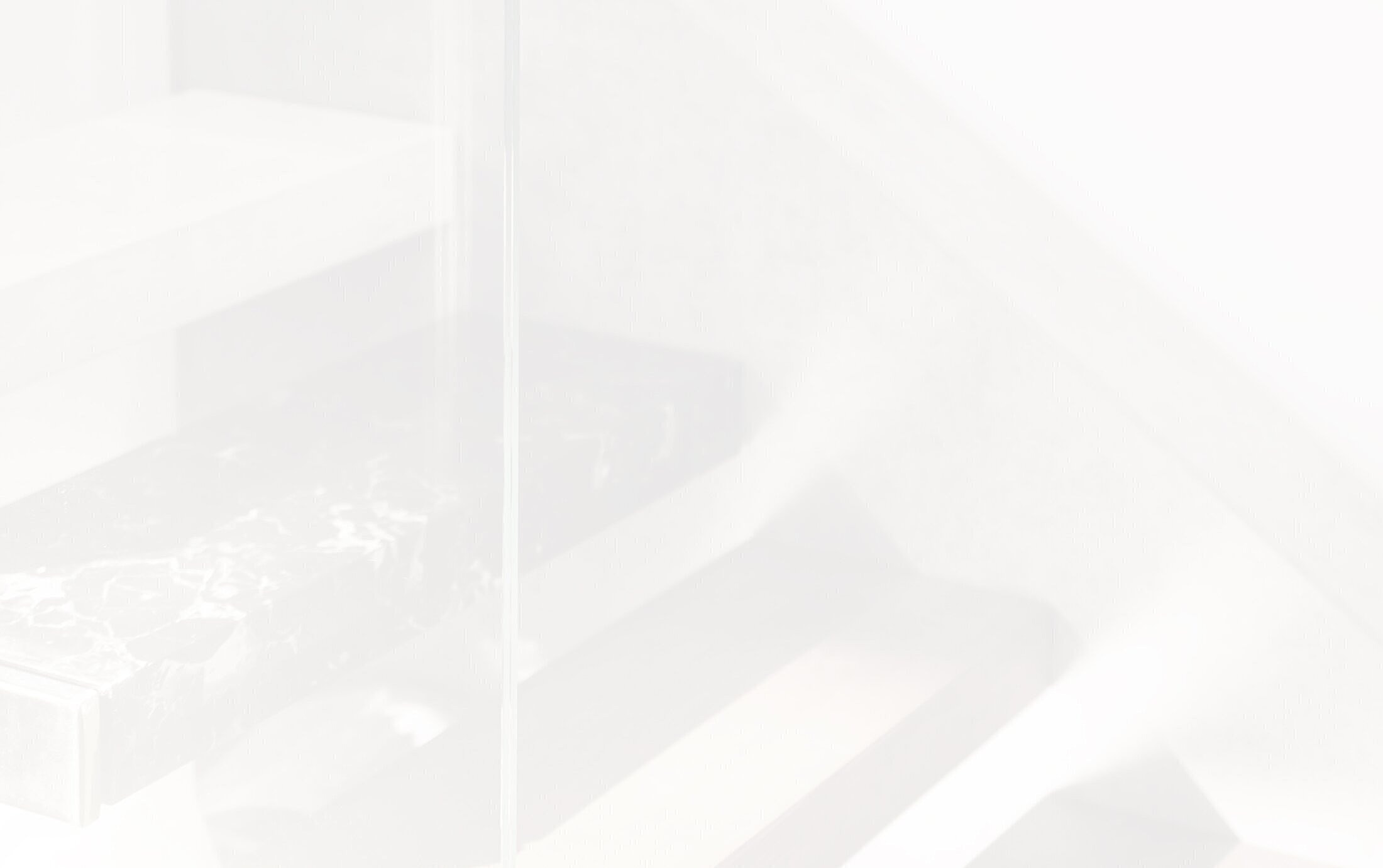 Modern staircase with glass and marble details.