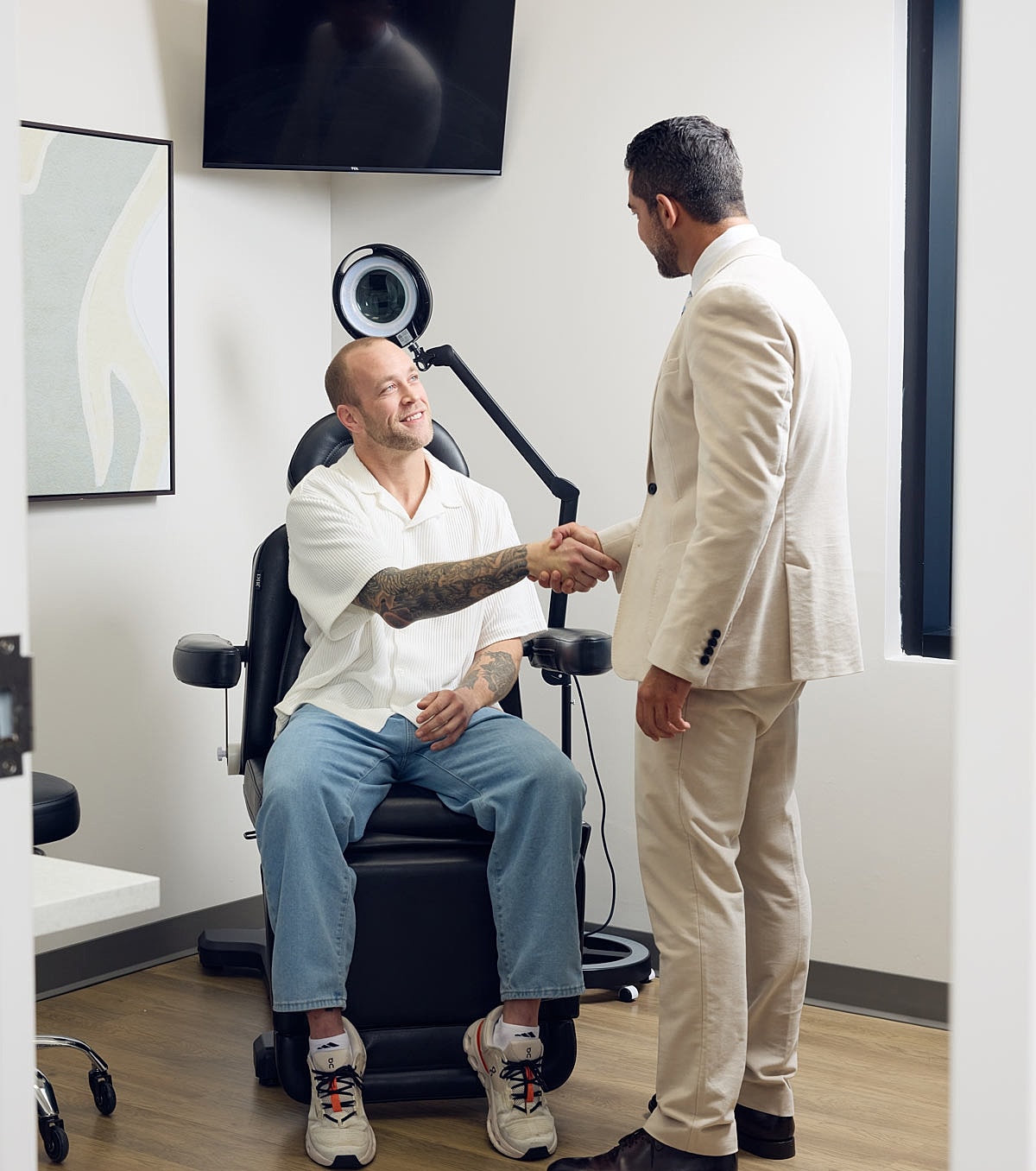 Patient and doctor shaking hands in office.