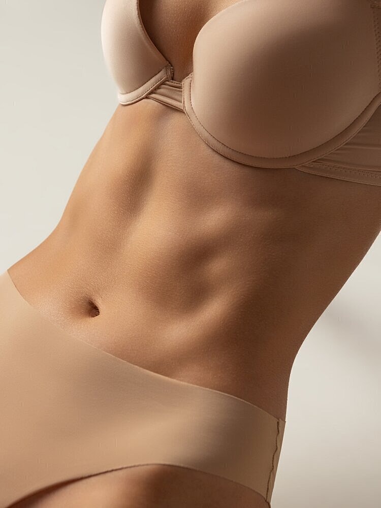 Close-up of torso in nude undergarments.