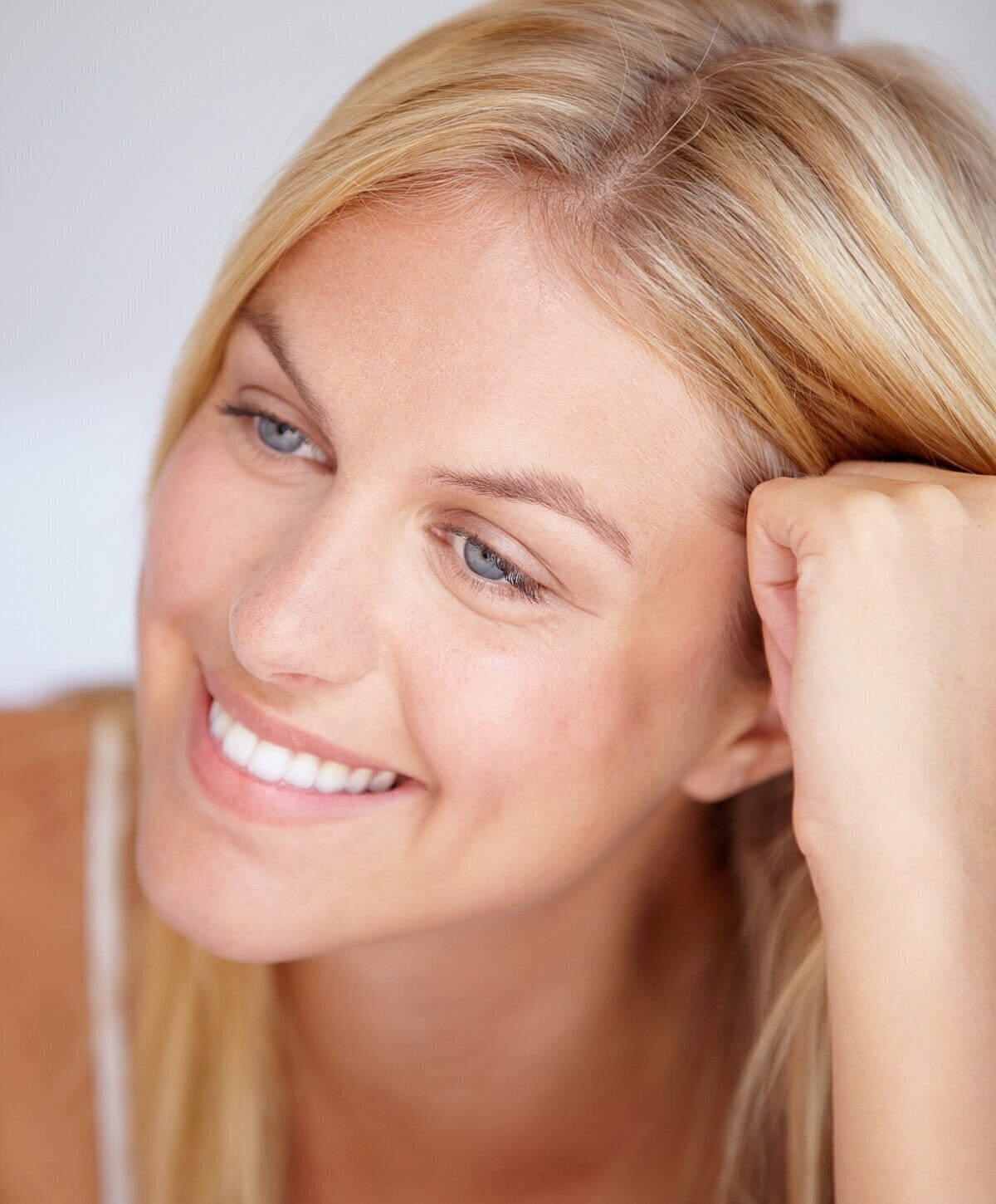 Smiling woman with blonde hair, relaxed expression.