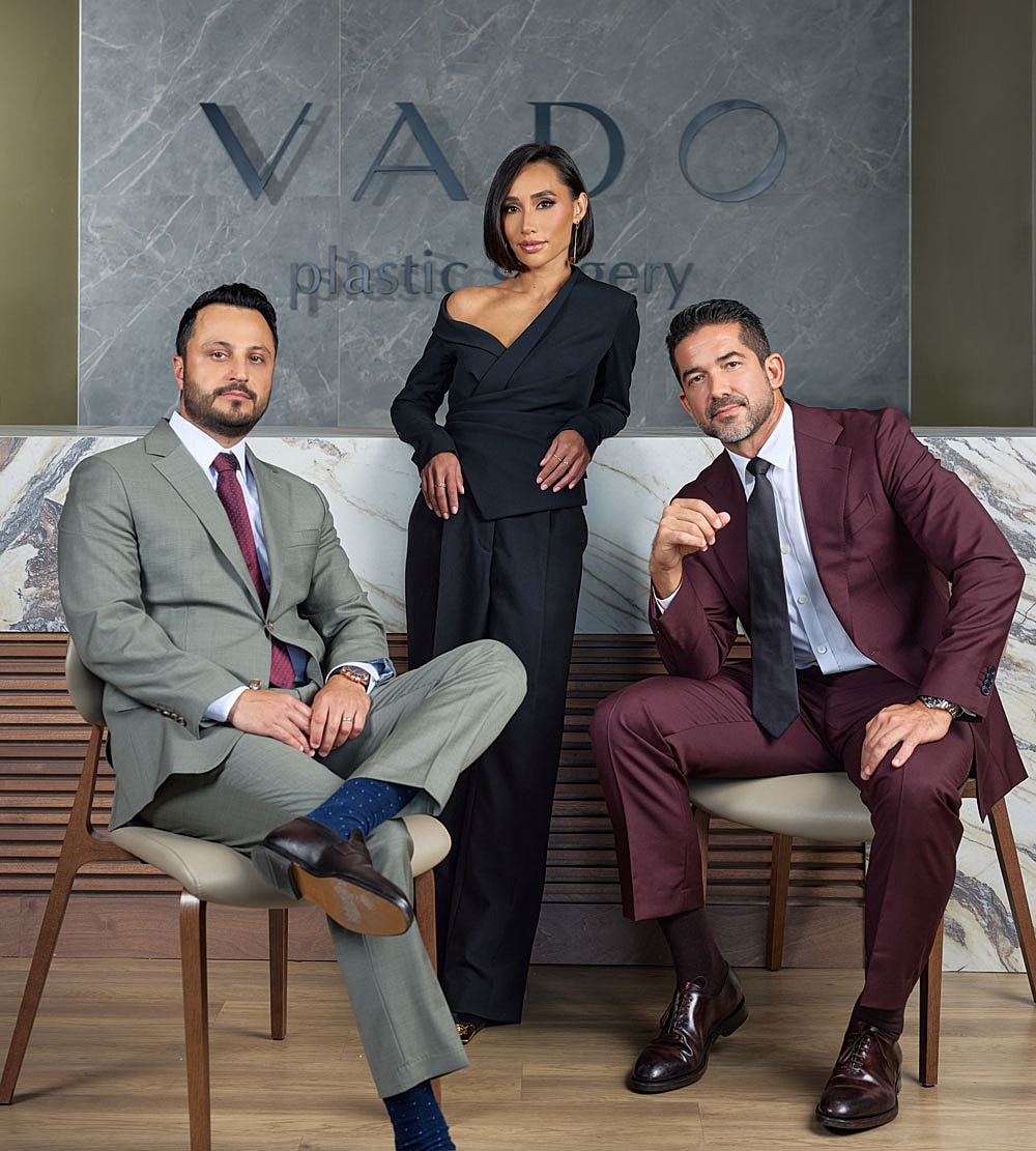 Three professionals in a plastic surgery office.