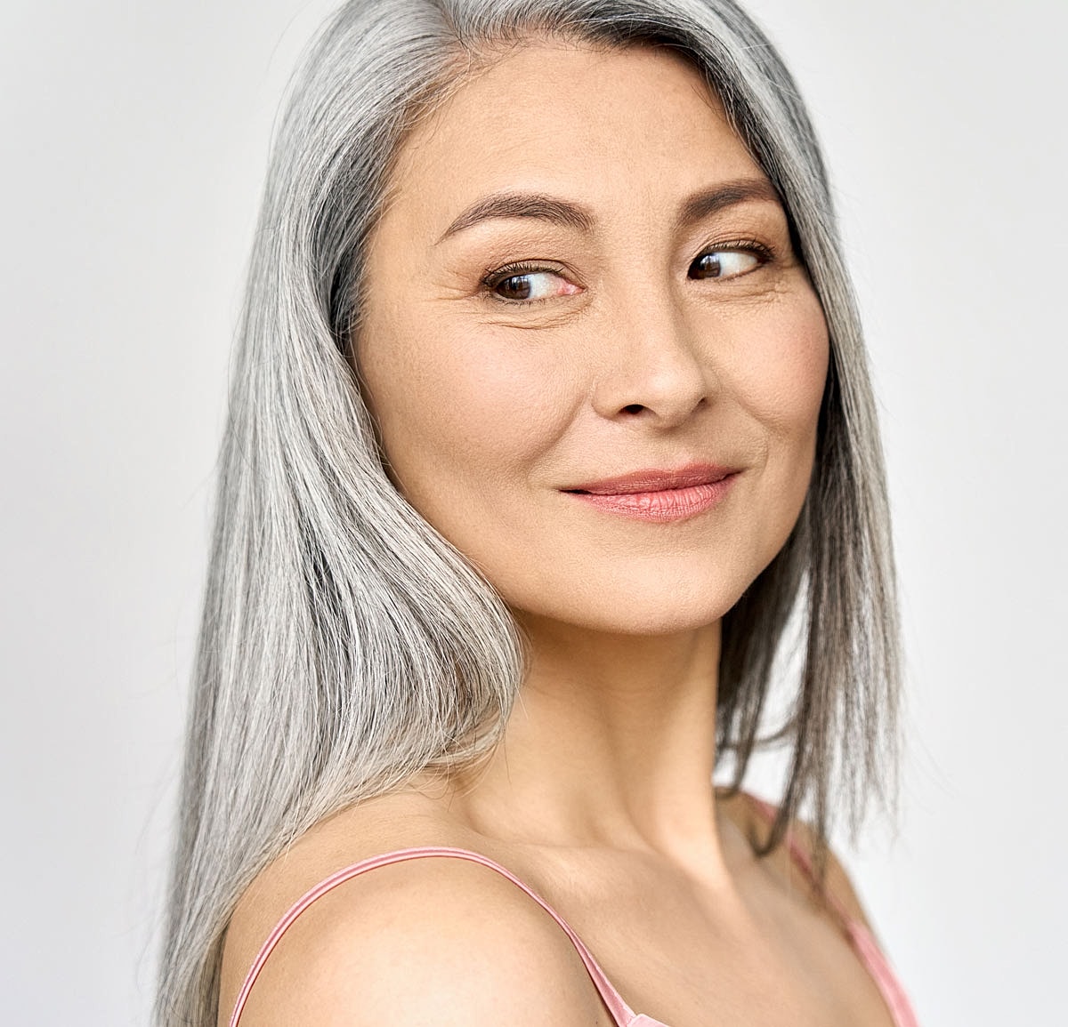 Smiling woman with long gray hair.