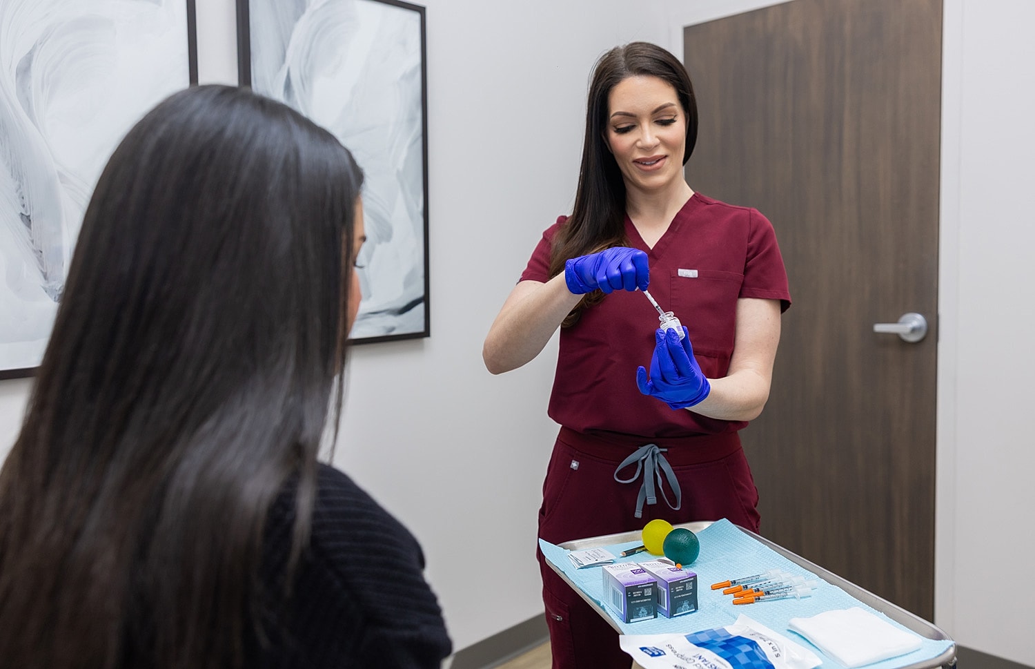 Medical professional preparing treatment for a patient.
