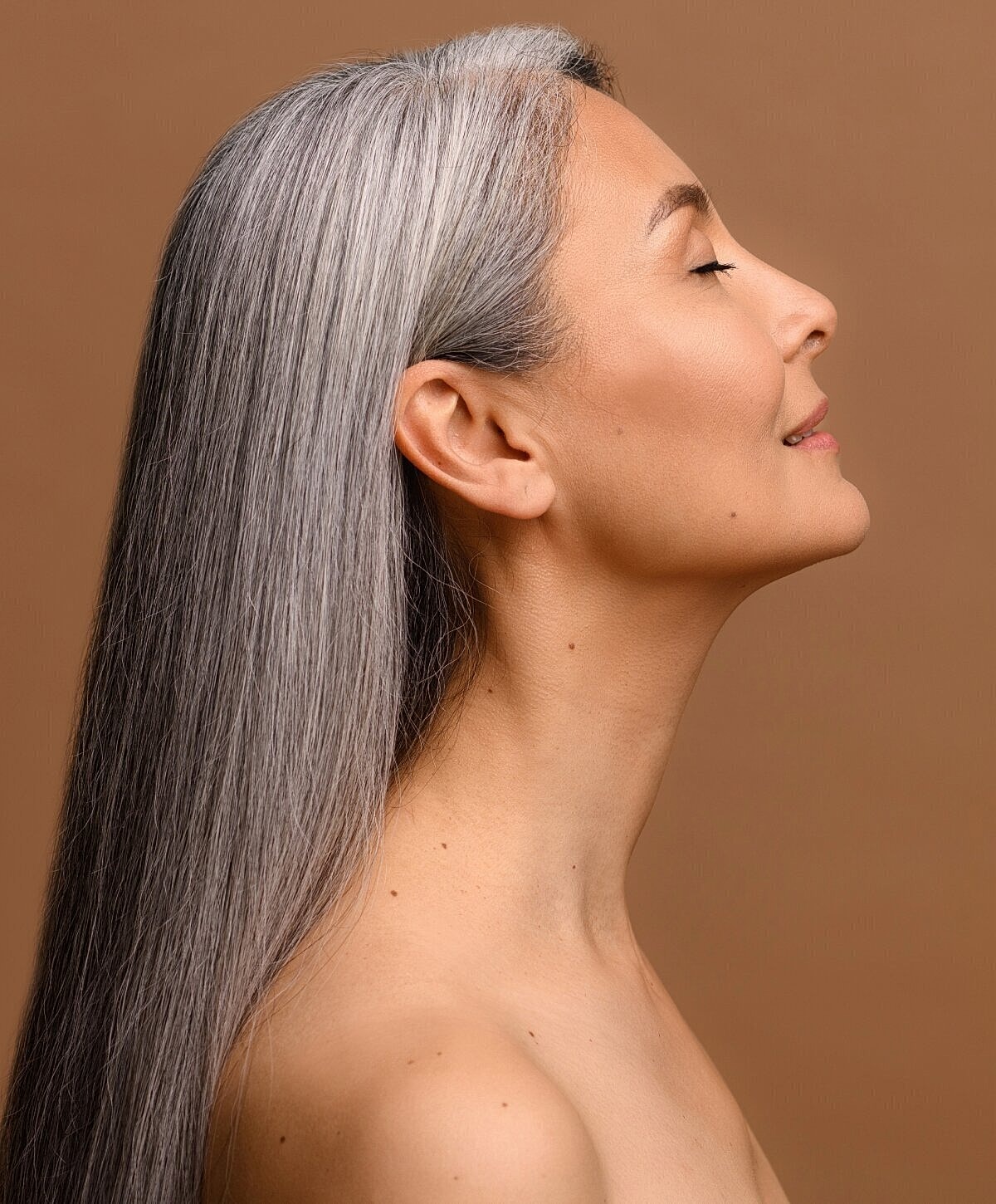 Profile of a woman with long gray hair