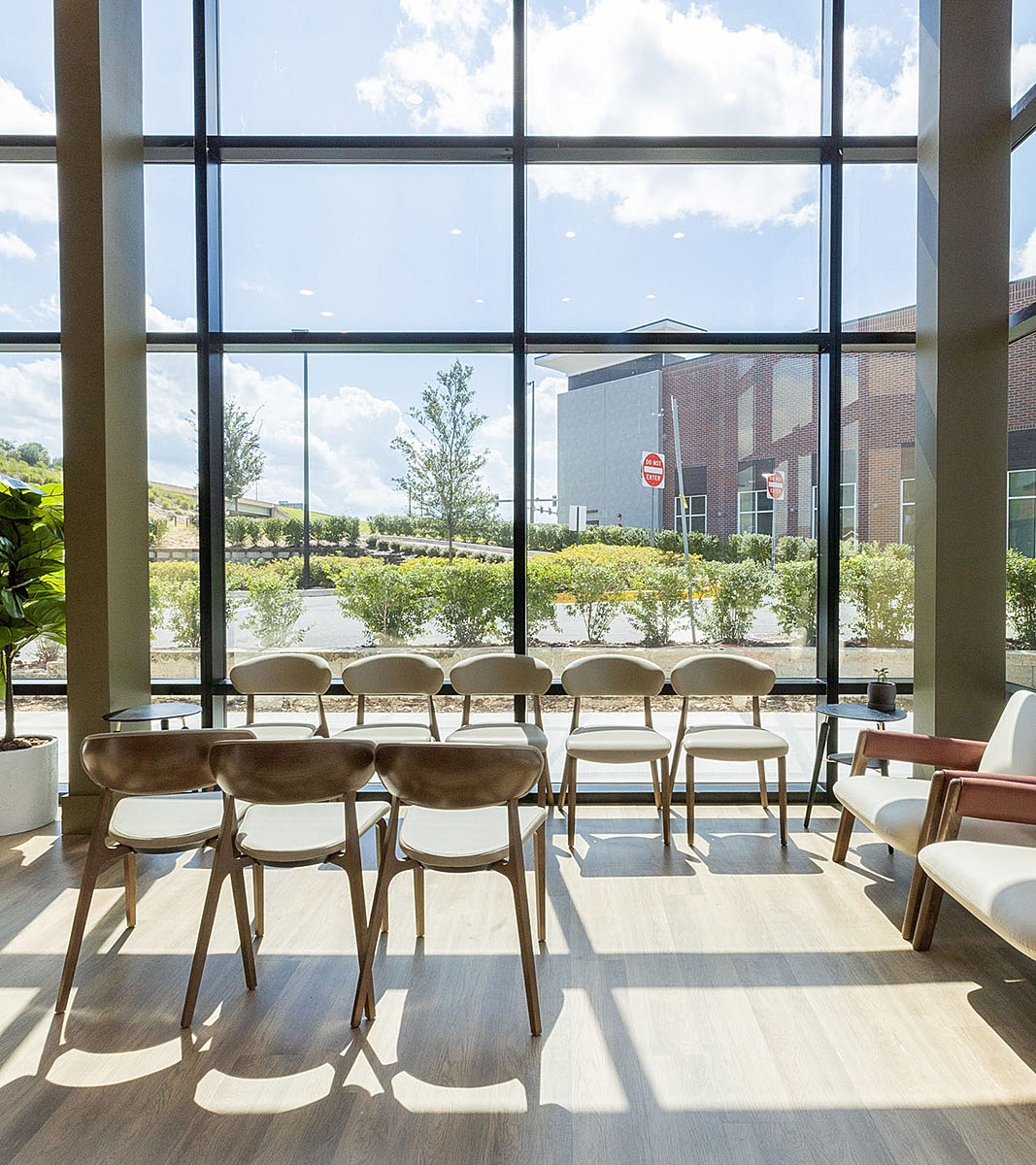Modern waiting area with large windows and chairs.