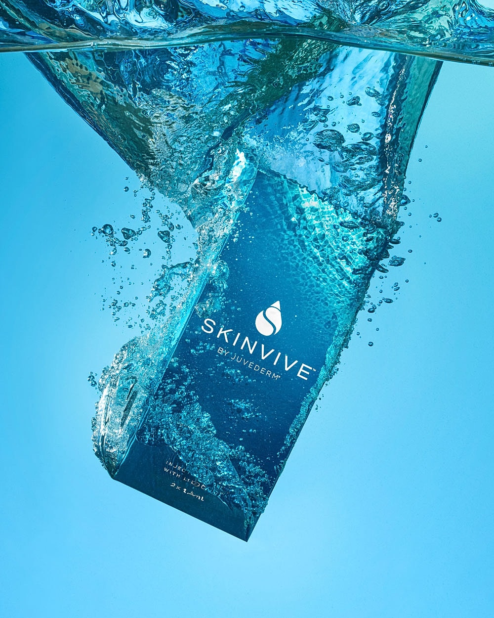 Skinvive product packaging submerged in water.