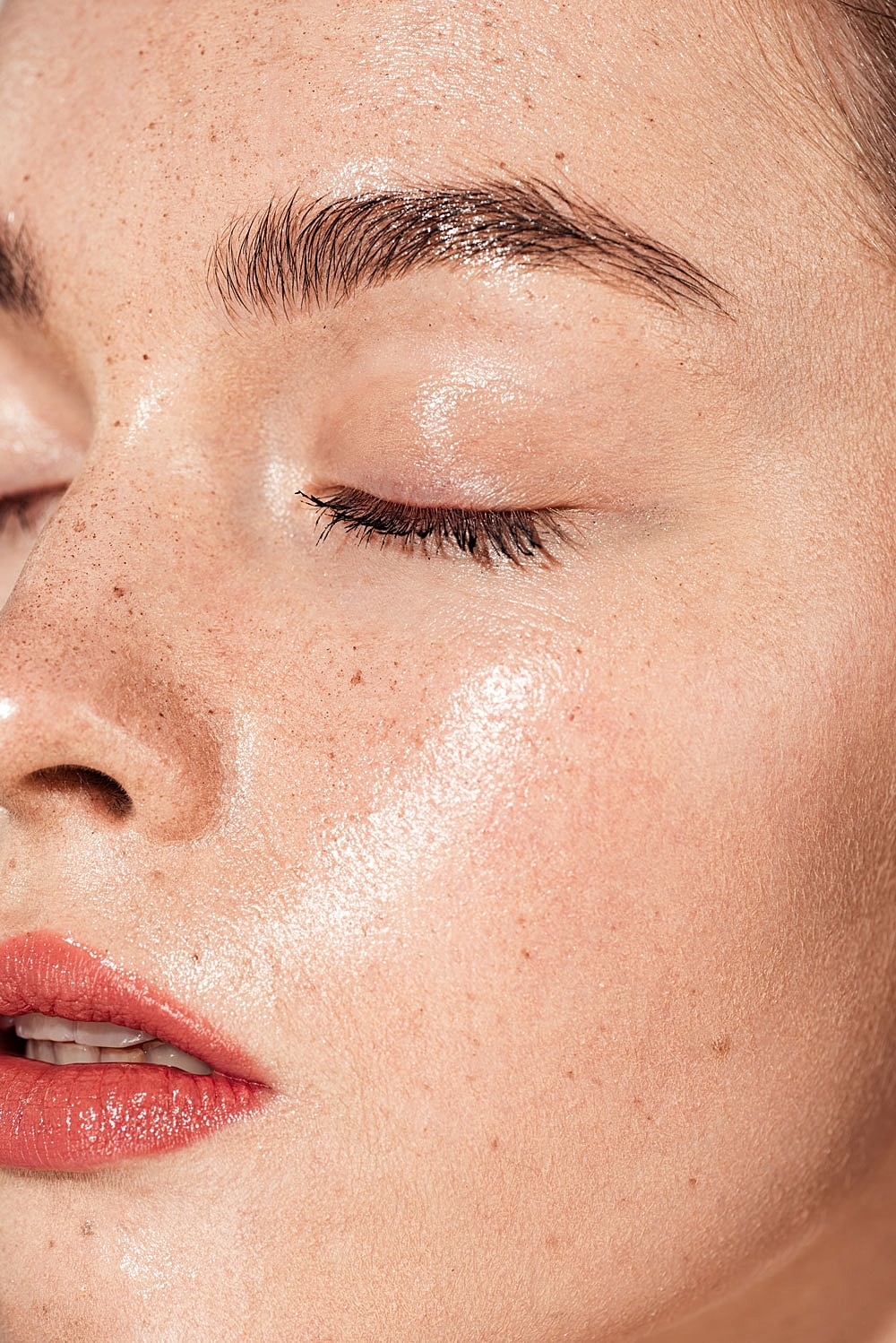 Close-up of lightly freckled, glowing skin.