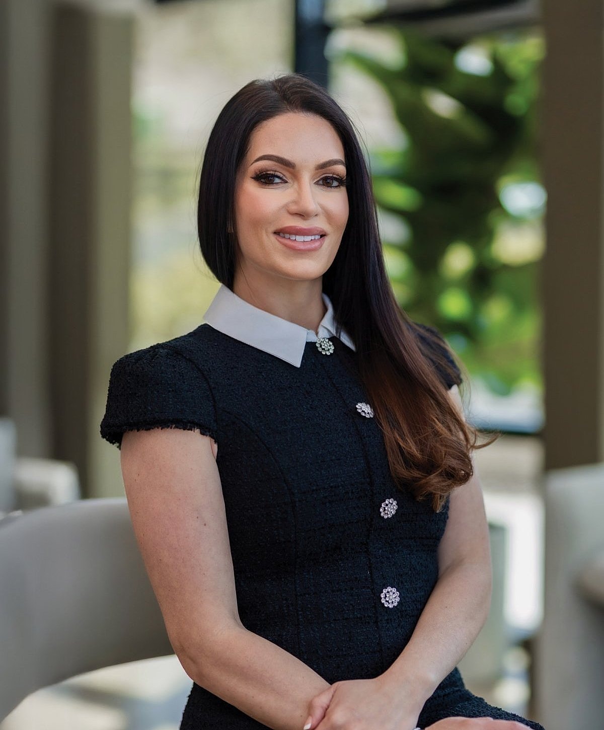 Professional woman smiling in a modern setting.