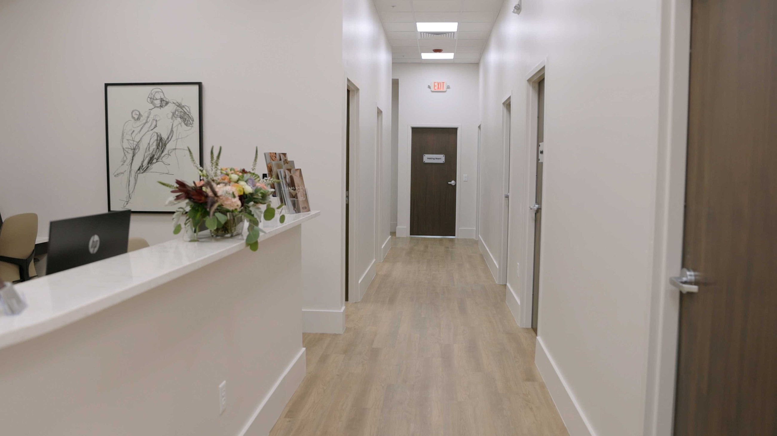 Modern medical office hallway with floral arrangement
