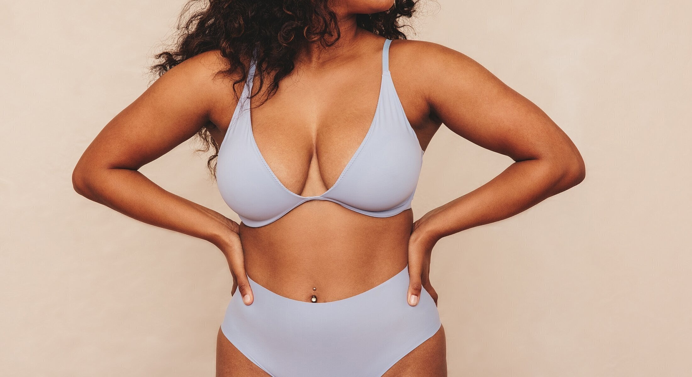 Model wearing light blue lingerie on neutral background.