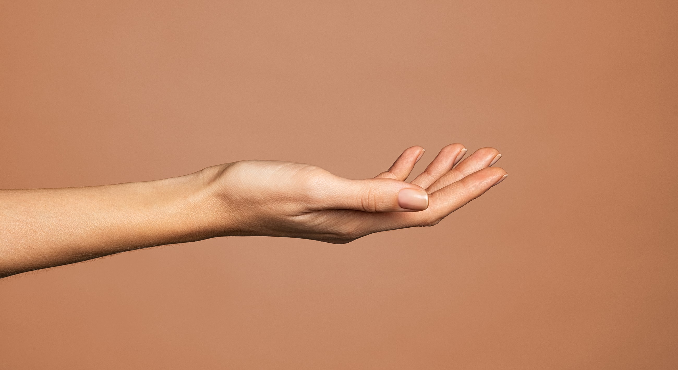 Outstretched hand against a neutral background.
