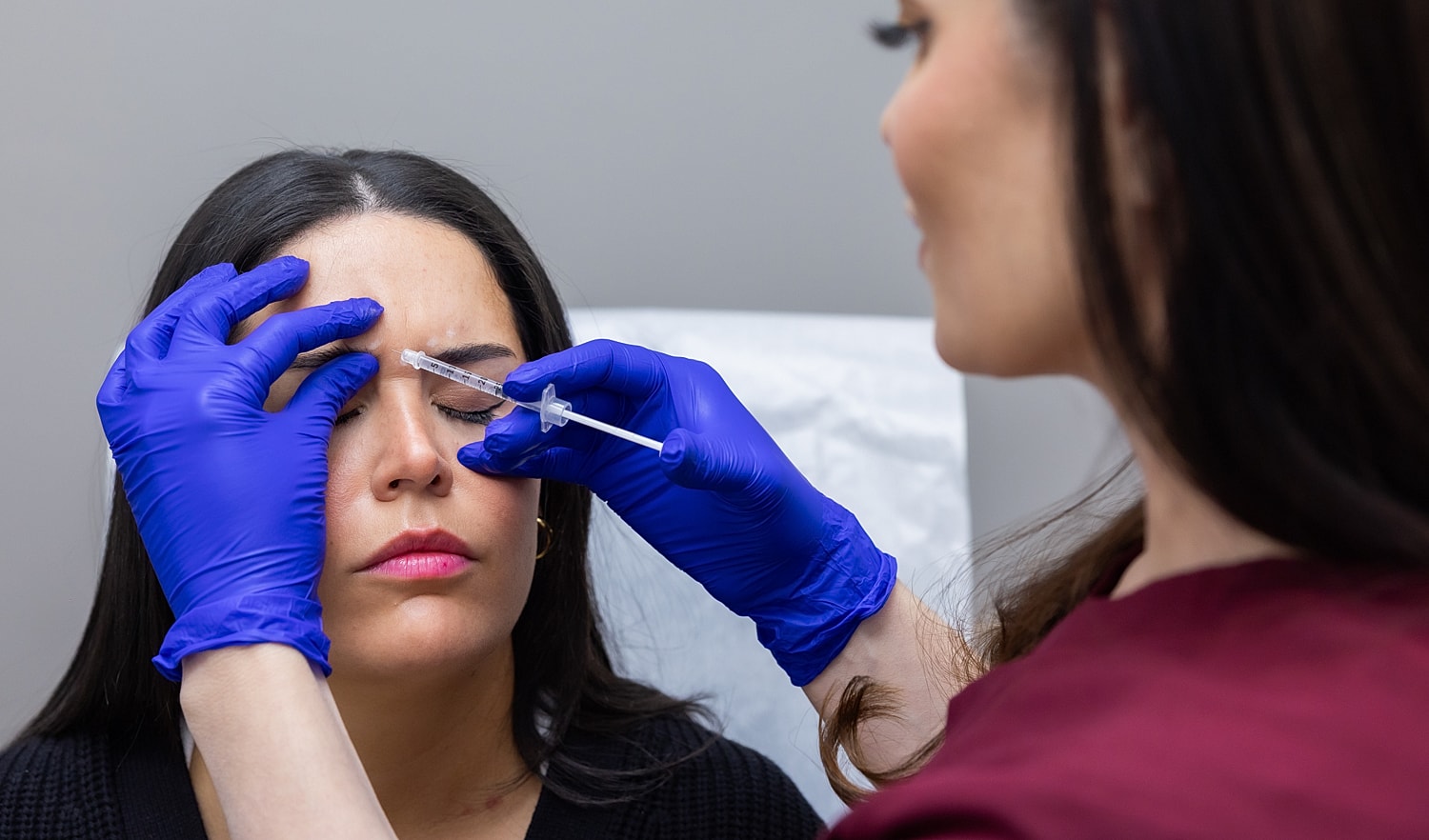 Woman receiving cosmetic injection treatment.